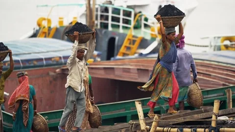 View of workers carrying coal baskets at Aminbazar, Bangladesh. Video stock 334992503