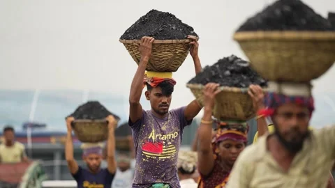 View of workers carrying coal baskets in Aminbazar, Bangladesh. Stock Footage 334992546
