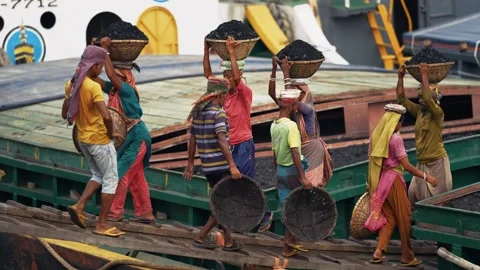 View of workers carrying coal on baskets in Aminbazar, Bangladesh. Video stock 334992853