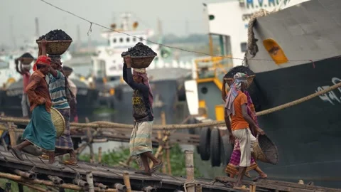 View of workers carrying coal baskets at Aminbazar, Bangladesh. Video stock 334993199