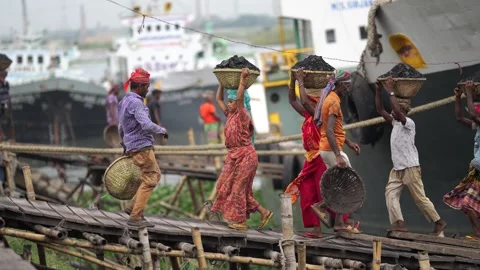 View of workers carrying coal baskets at Aminbazar, Bangladesh. Video stock 334994262