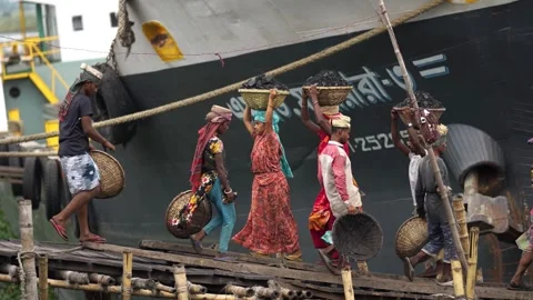 View of workers carrying coal baskets from a ship, Bangladesh. Stock Footage 334994318