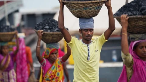 View of workers carrying coal baskets in Aminbazar, Bangladesh. Video stock 334994363