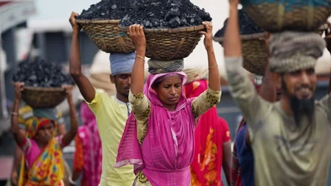View of workers carrying coal baskets in Aminbazar, Bangladesh. Video stock 334994429