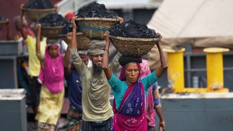 View of workers carrying coal baskets in Aminbazar, Bangladesh. Video stock 334994495