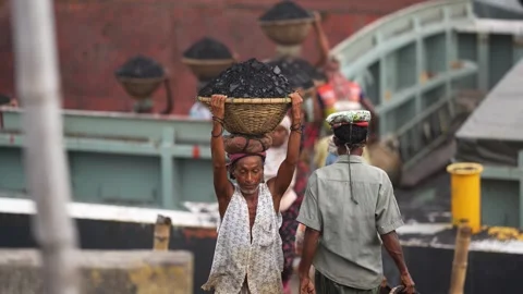 View of workers carrying coal baskets in Aminbazar, Bangladesh. Video stock 334994709