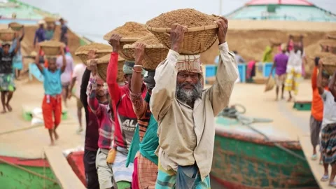 View of workers carrying sand baskets at Aminbazar, Bangladesh. Video stock 334994999