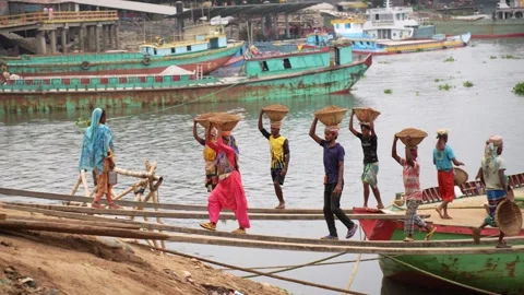 View of workers carrying sand baskets on their heads, Bangladesh. Video stock 334995884