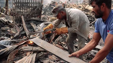 View of workers cutting metal with a blowtorch in a scrapyard, Bangladesh. Stock Footage 335600180