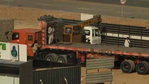 View Of Workers On Empty Flat Bed Trailer On Truck In Pakistan. Slow Stock Footage 168456859