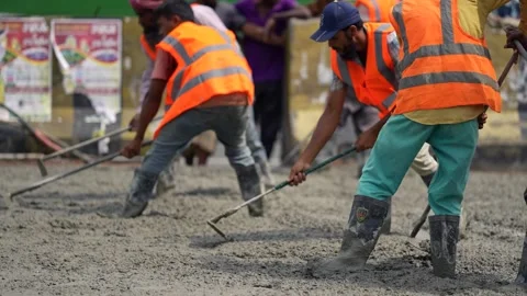 View of workers leveling concrete at a construction site, Bangladesh. Video stock 334992424