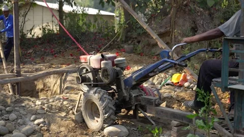 View of workers operating a drilling machine in Dhangadhi, Nepal. Video stock 335471650
