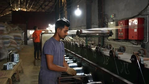 View of workers operating machinery in a factory, Bangladesh. Video stock 334950536