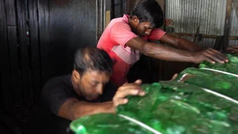 View of workers processing plastic bottles in Bogura, Bangladesh. Stock Footage 336424624