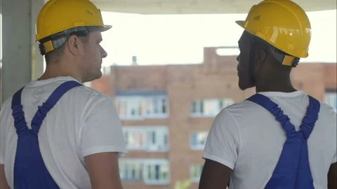 View of a workers watching some details on a construction Видео 116058637