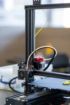 View of a working 3D printer mechanism printing a plastic part 写真素材