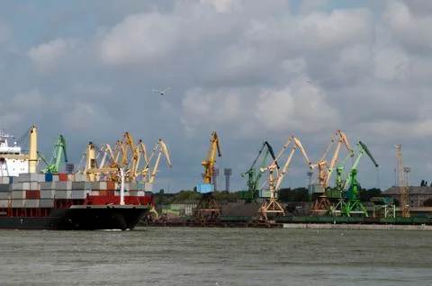 View of working harbor with loading docks and cargo vessel Stock Photos