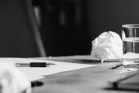 View of the workplace. Open notebook over table. Black and white photography. Stock Photos