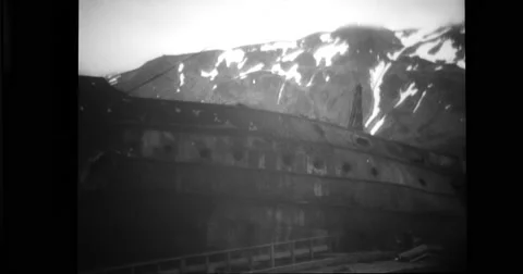 View of wrecked ship and snowcapped mountains at Dutch harbour Stock Footage 43503614