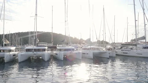 View from the yacht entering the marina at sunset in bright sunlight Stock Footage