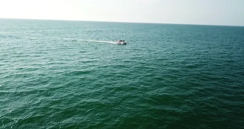 View of yacht speeding by the coast Stock Footage 104937931