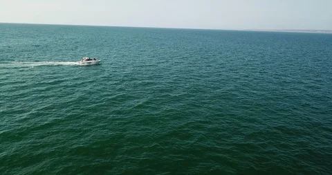 View of yacht speeding by the coast Stock Footage 104937994
