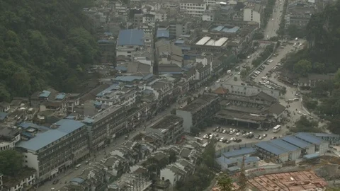 View of the Yangshuo town from the mountain. Traffic on the road Stock Footage 103469147