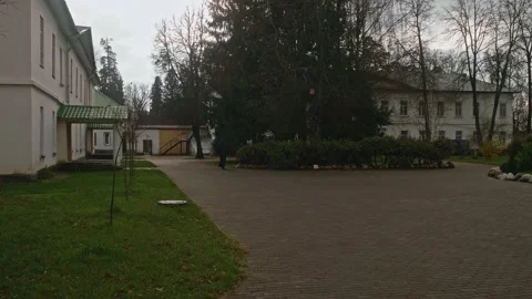 View of yard of Nikolo-Berlyukovsky monastery and a monk in balck clothes Stock Footage 165898193