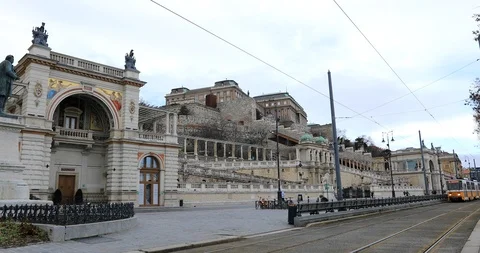 A view of yellow tram passes old buildings in Budapest Stock Footage 102232989