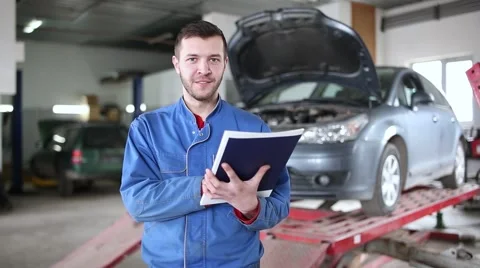 View of a Young attractive mechanic working at the garage Stock Footage 61580635