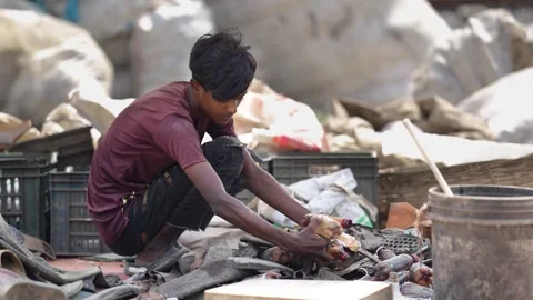 View of a young boy sorting recyclables in Bogura, Bangladesh. Stock Footage 336424173