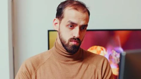 View of young game developer working on computer Foto stock