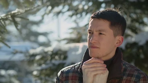 View of a young man rubbing his hands during a winter walk. A brunette man Stock Footage 237327737