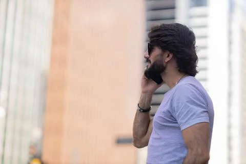 View of young man using a smartphone at day time with city view landscape in  Stock Photos