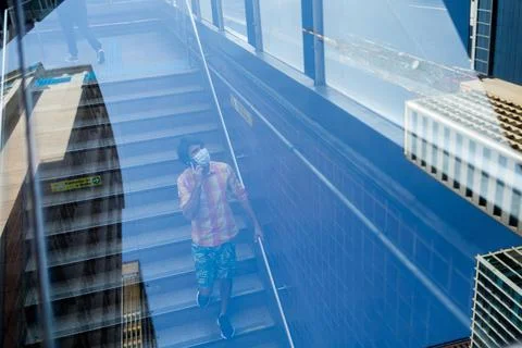 View of young man using a smartphone at day time going the subway stairs. Hig Stock Photos
