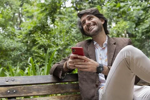 View of young man using a smartphone at twilight Stock Photos