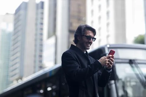 View of young man using a smartphone at twilight Stock Photos