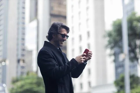 View of young man using a smartphone at twilight Stock Photos