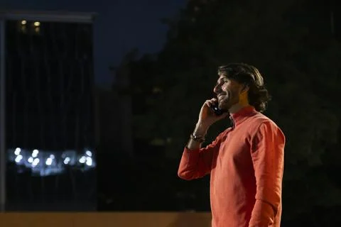 View of young man using a smartphone at night Stock Photos