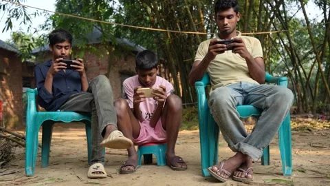 View of young men using smartphones in Bogura, Bangladesh. Video stock 335025054