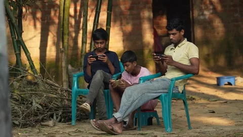 View of young men using smartphones in Bogura, Bangladesh. 動画素材 335025493