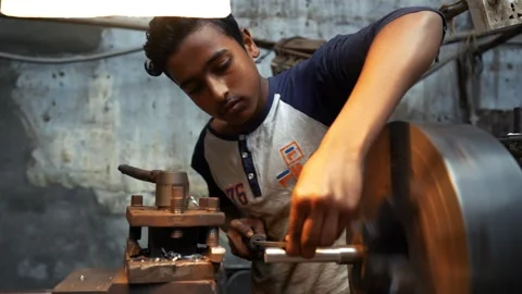 View of a young worker operating a lathe machine, Bangladesh. Video stock 335584742