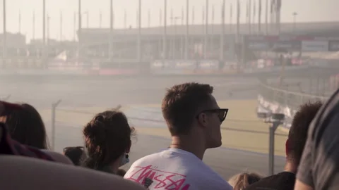 Viewer watches a drifting competition in the background. Footage. Motor sport 스톡 동영상 219618086