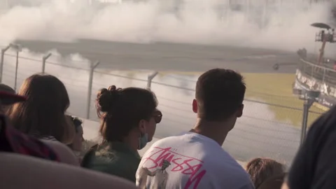 Viewer watches a drifting competition in the background. Footage. Motor sport Stock-Footage 224654256