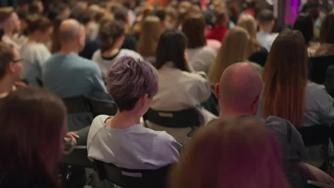Viewers absorb self-improvement techniques, focus on violet-haired girl with Stock Footage 269969964