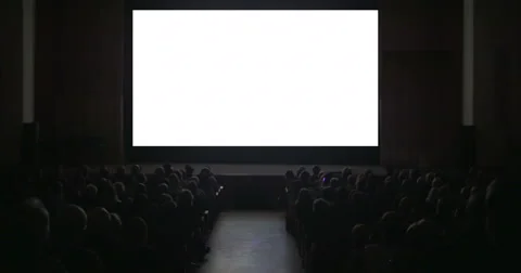 Viewers in dark cinema hall with blank screen Stock Footage