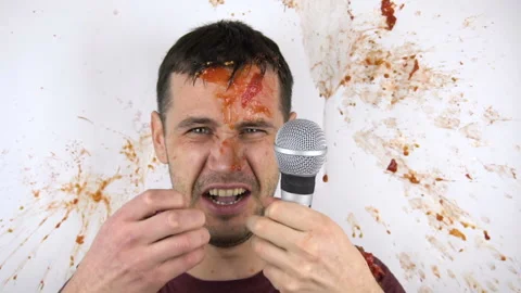 Viewers throw rotten tomatoes at a failed stand-up comedian. A young attractive Stock Footage 146892309