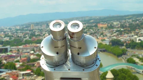 Viewing binoculars on background of city and mountains on sunny day.  Stock Footage 112885216