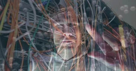 Viewing cables IT technician in zip-up jacket testing switches in server room Stock Photos