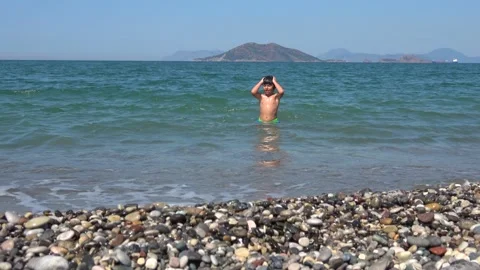 Viewing a child having fun in the sea waters alone 2 Stock Footage 142989459